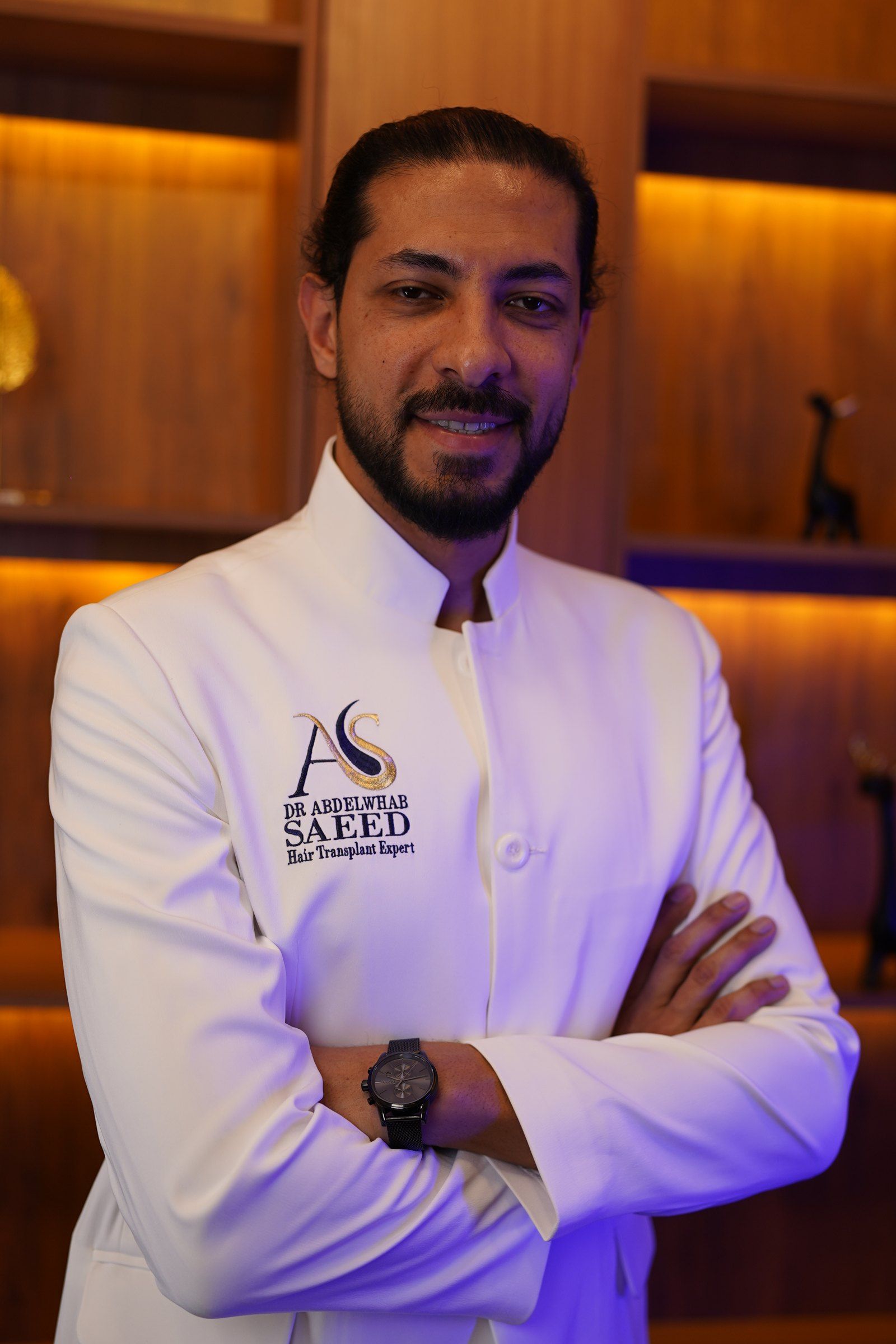 د. عبدالوهاب سعيد بجاكيت العيادة الأبيض في مكتبه